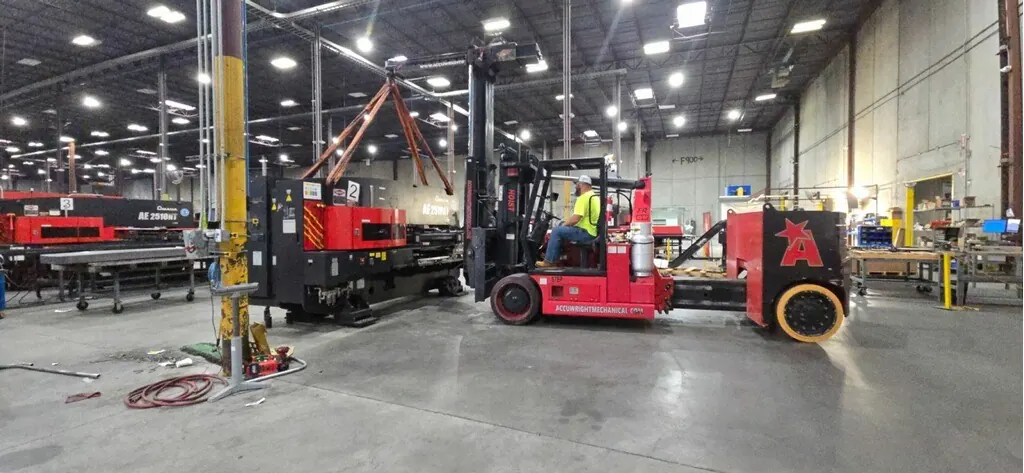 An Accuwright forklift positioning a machine into its final location
