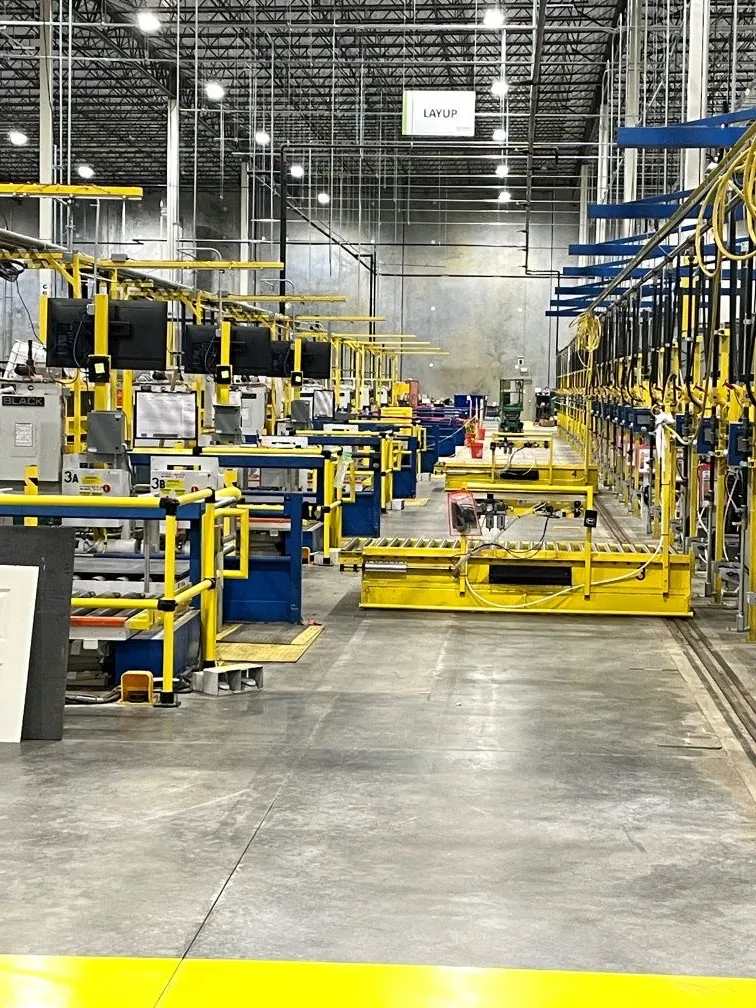A completed yellow and blue production layup line in a large clean facility