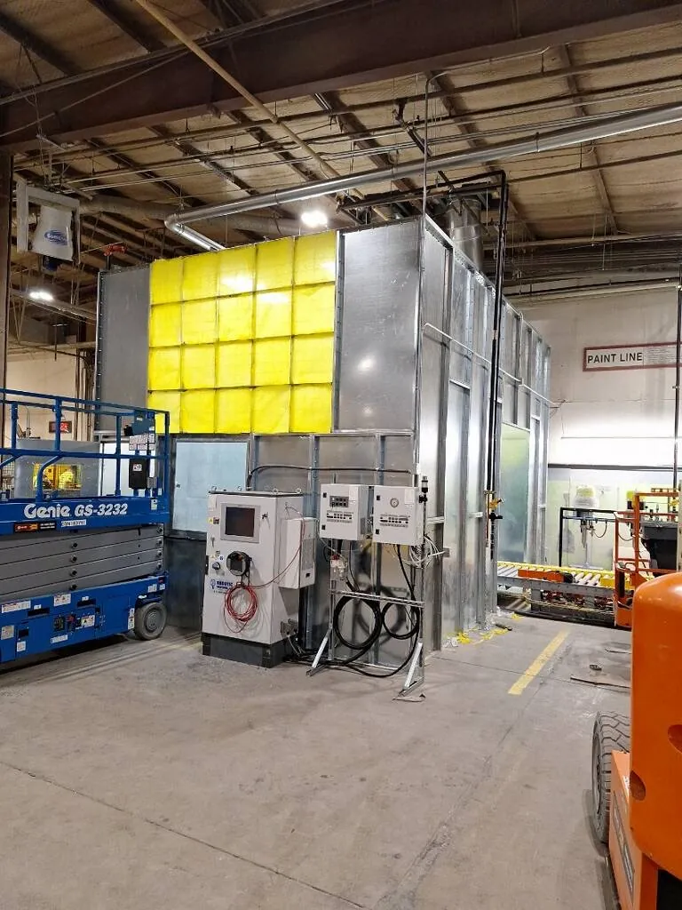 An installed paint-line enclosure with control panels, ductwork and filtration wall