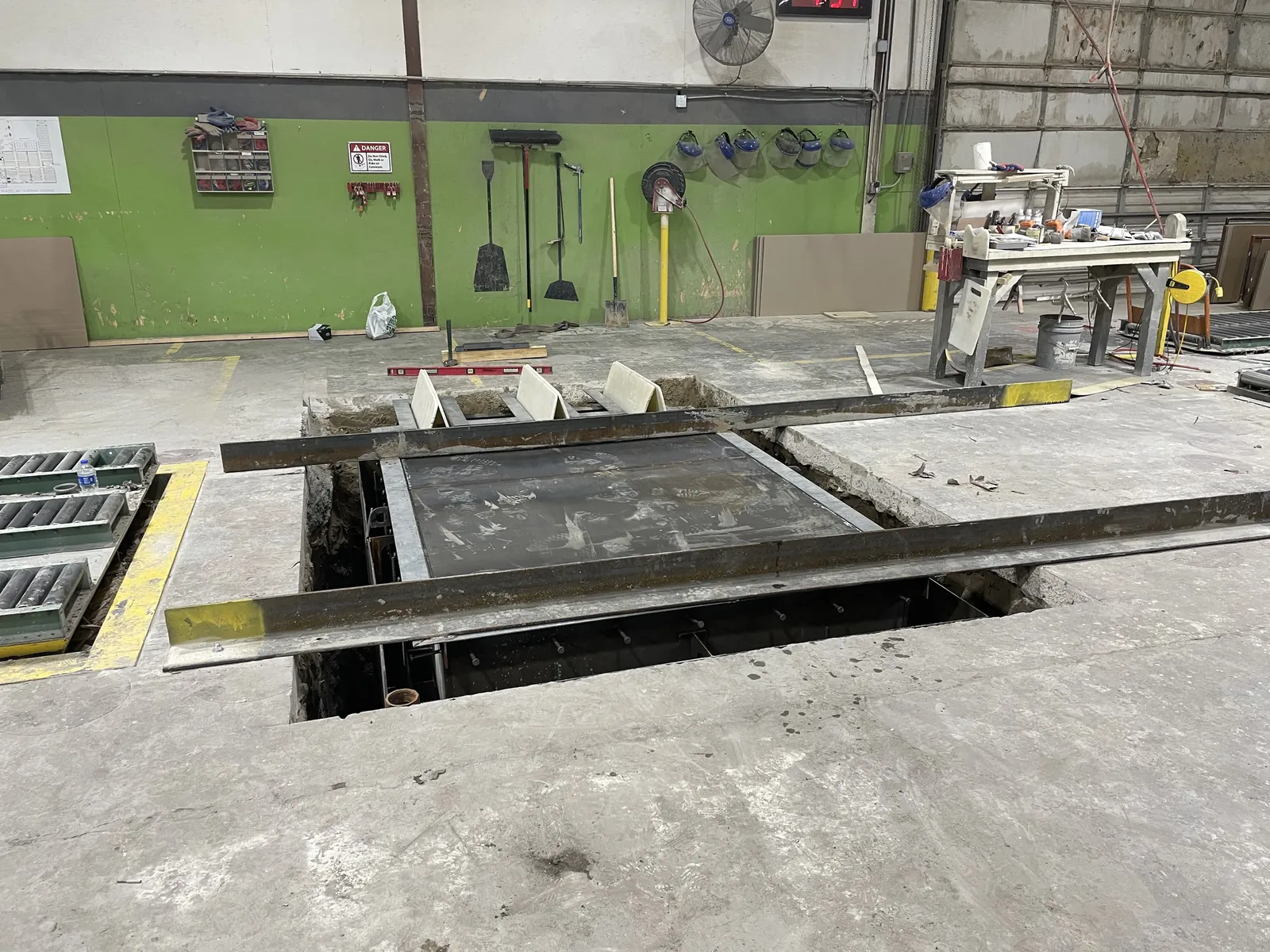 A steel-framed equipment pit under construction inside an industrial plant