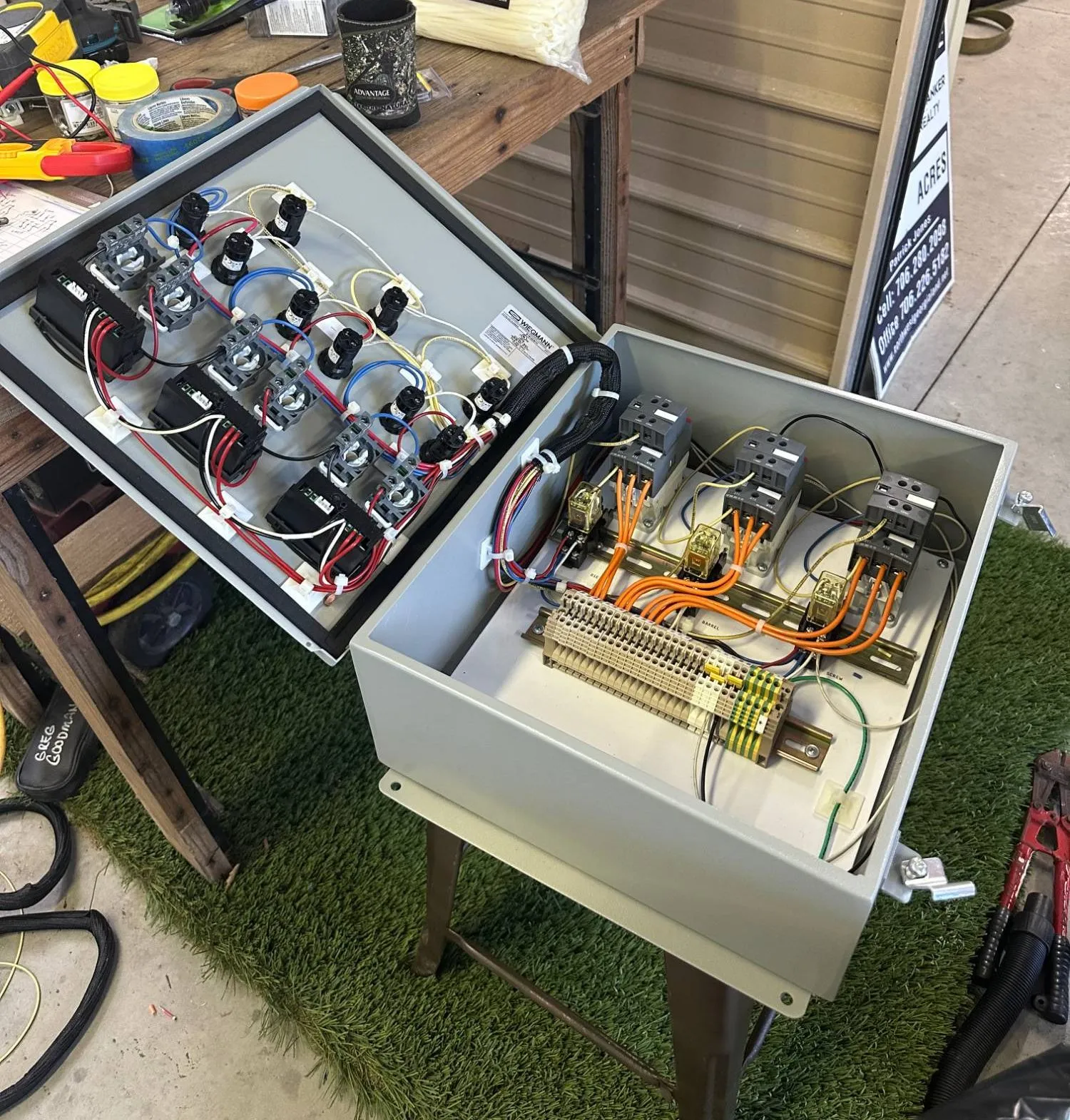 Two industrial control panels under construction on the bench with DIN rail and dressed wiring