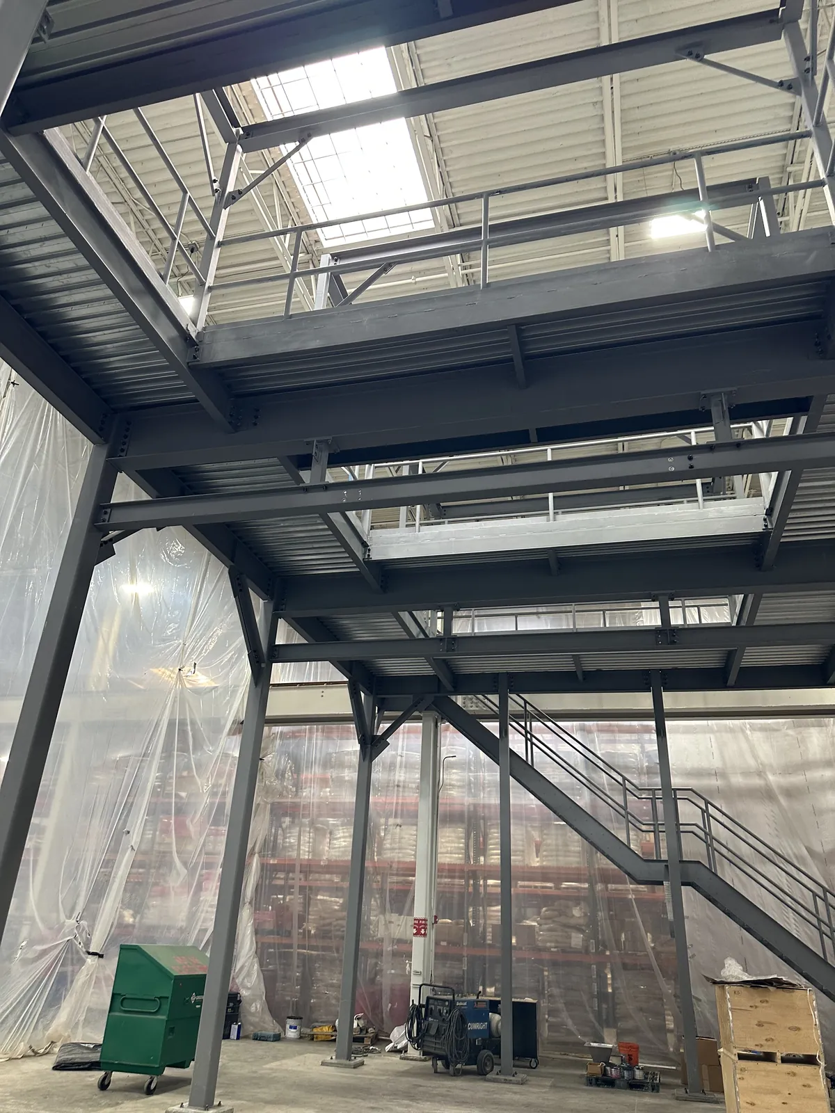 Inside a newly erected structural steel mezzanine in an operating warehouse