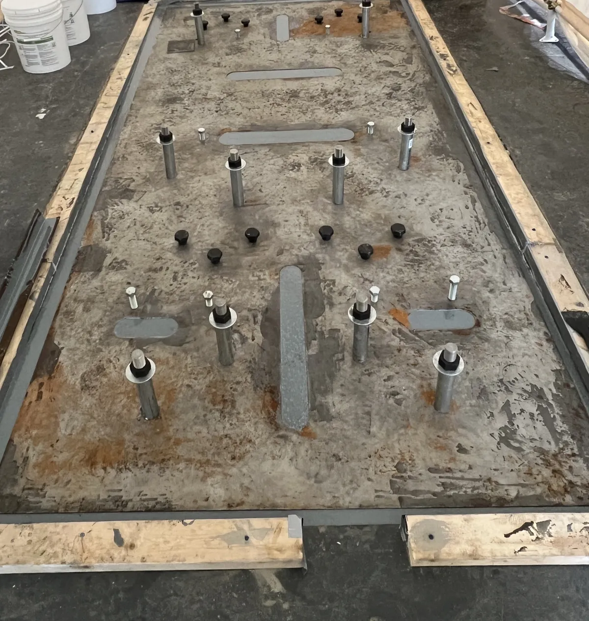 Anchor bolts set and grouted in a machine foundation ahead of machinery installation