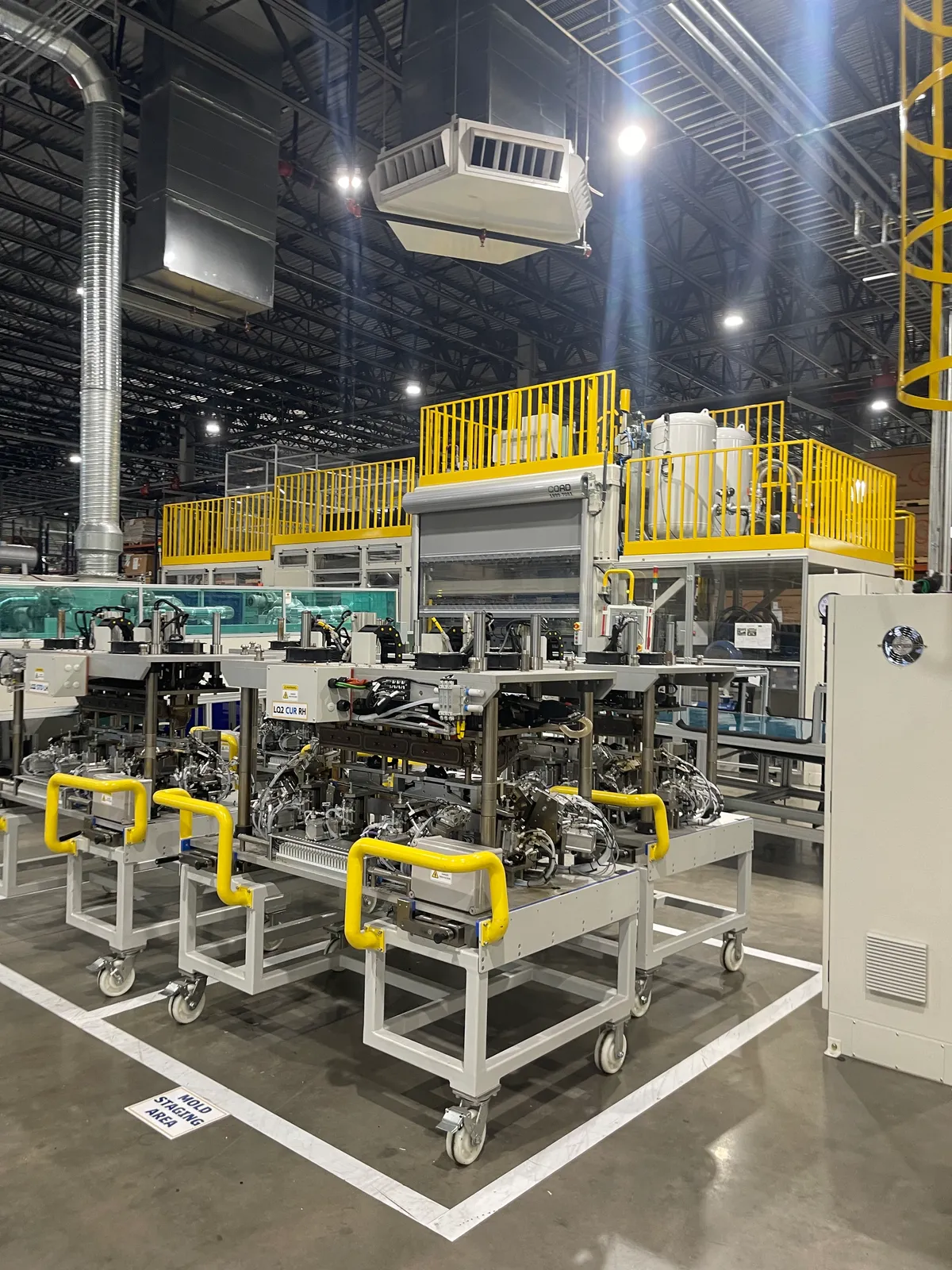Tooling staged on carts beside a newly installed production line