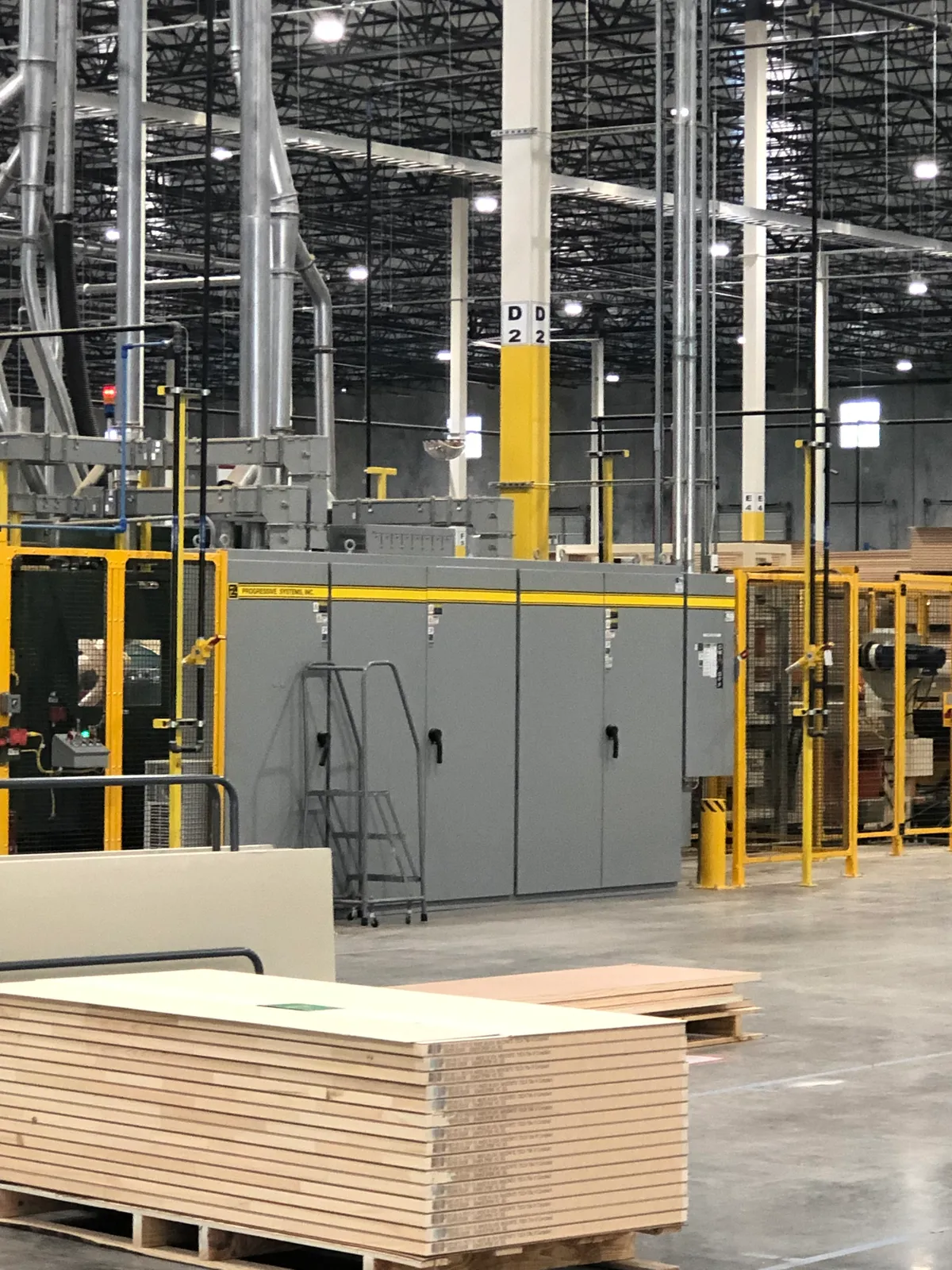 Installed control enclosures with machine guarding and dust collection in a bright clean plant