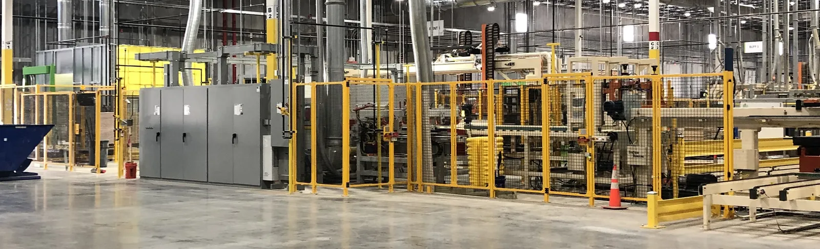 An installed production line with control enclosures, machine guarding and clean cable management in a bright plant